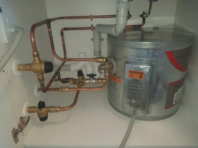 Hot water cylinder under kitchen sink Repairs made to hot water cylinder under kitchen sink